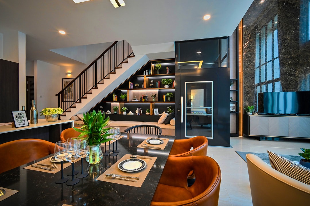 Recessed ceiling lighting and wall-mounted lights near the staircase area provide soft and ambient illumination.